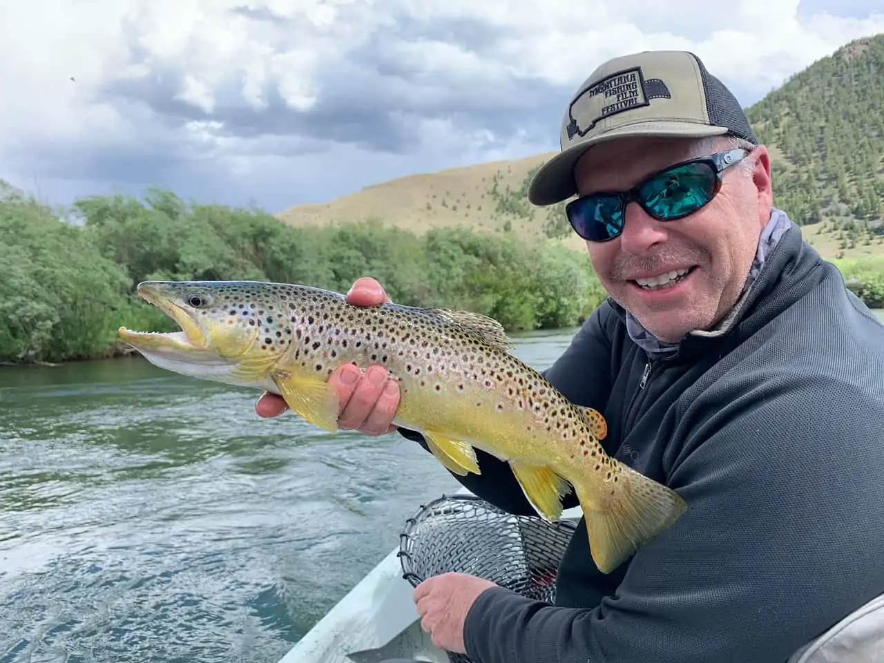 Man holding fish on boat in the Missouri river