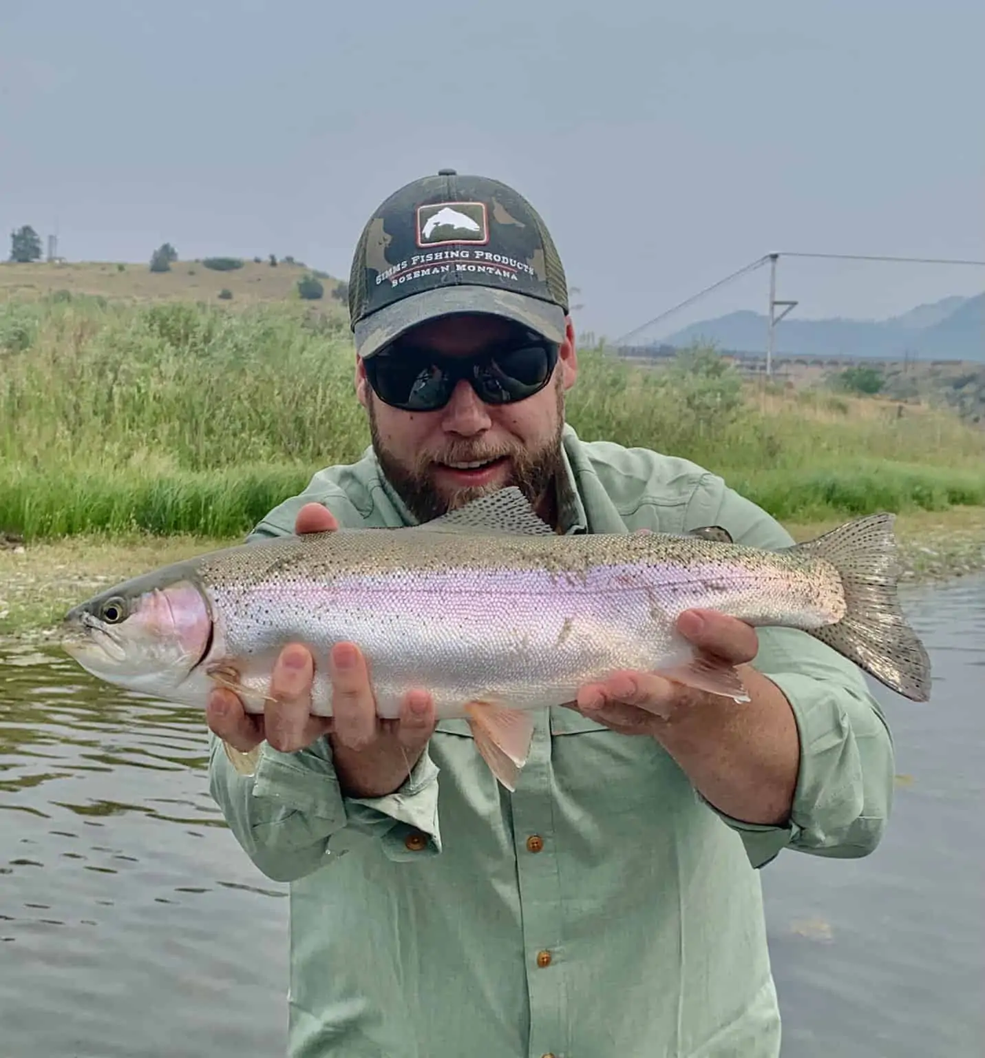 Man holding rainbow fish